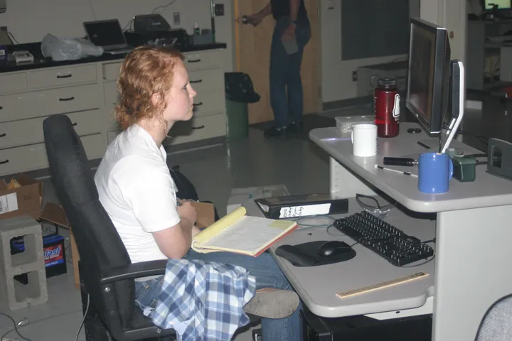 Keely recording data at a lab workstation