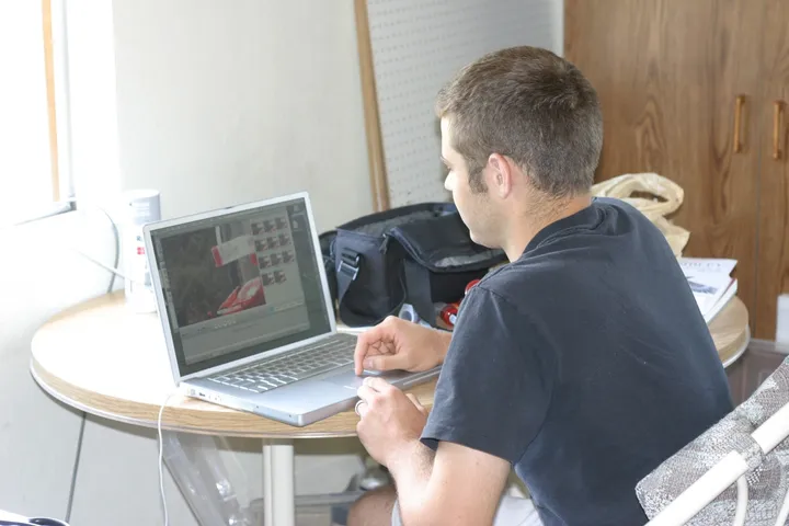 Phil reviewing video on a laptop at a field station