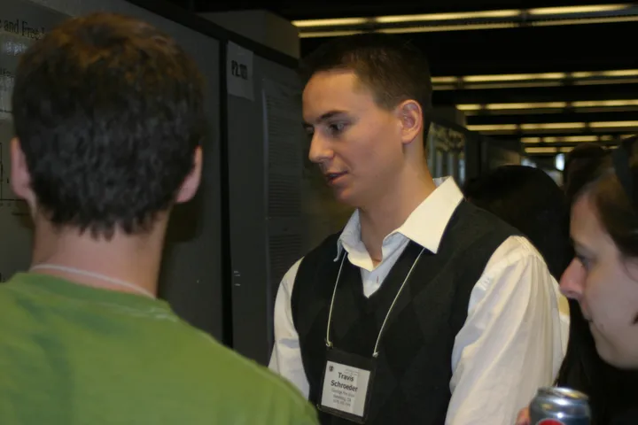 Travis presenting his poster at a scientific meeting